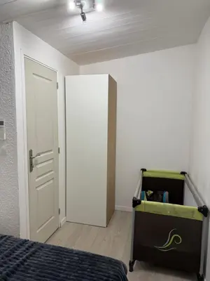 a bedroom with a bed and an open door at Maison a la plage in Poggio-Mezzana