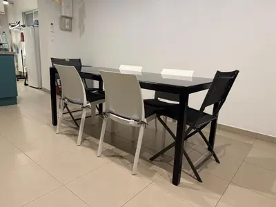 a black table and chairs in a kitchen at Maison a la plage in Poggio-Mezzana