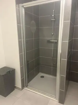 a shower with a glass door in a bathroom at Appartement Rocade in Ajaccio