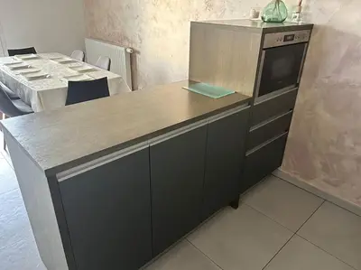 a kitchen with a counter with a counter top at Appartement Rocade in Ajaccio