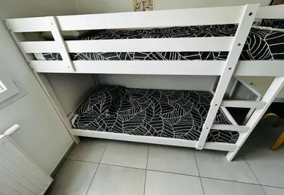 a closet with white shelves with black and white patterns at Appartement Rocade in Ajaccio
