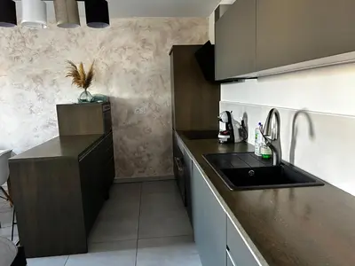 a kitchen with a sink and a counter top at Appartement Rocade in Ajaccio