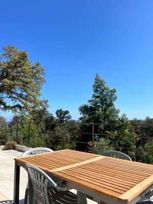 a wooden table and chairs on a patio at Casa di Cortanni in Castellare-di-Casinca