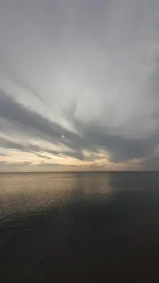 a large body of water with a cloudy sky at Casa di Cortanni in Castellare-di-Casinca