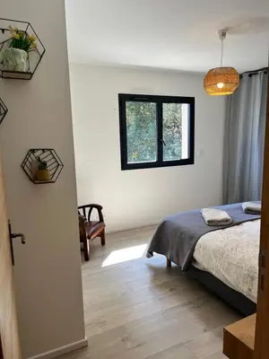 a bedroom with a bed and a window at Casa di Cortanni in Castellare-di-Casinca