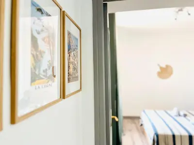a room with two framed pictures on a wall at Front de mer Beau T3 climatisé Balcon Parking Ajaccio in Ajaccio