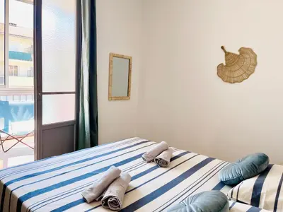 a bedroom with a bed with towels on it at Front de mer Beau T3 climatisé Balcon Parking Ajaccio in Ajaccio