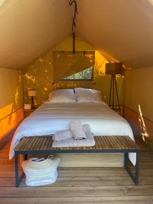 a bedroom with a bed in a tent at A Malgrana - Tente lodge hébergement insolite in Coti-Chiavari