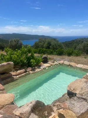 a swimming pool with a view of a lake at A Malgrana - Tente lodge hébergement insolite in Coti-Chiavari