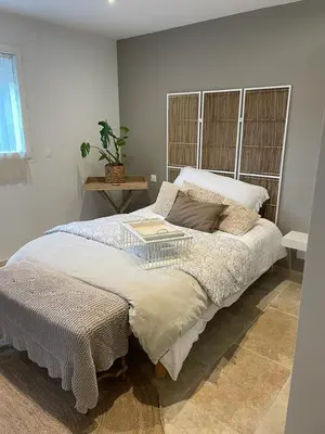 a bedroom with a large bed with a table on it at Appartement casa Di l Ortu in Ajaccio