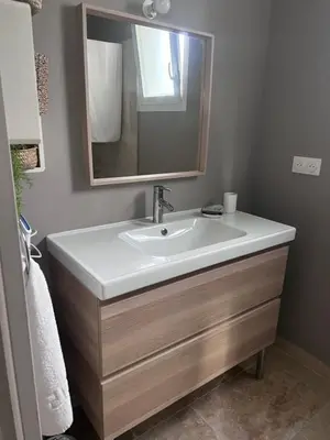 a bathroom with a sink and a mirror at Appartement casa Di l Ortu in Ajaccio