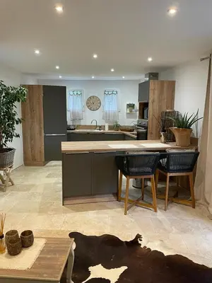a kitchen with a table and chairs in a room at Appartement casa Di l Ortu in Ajaccio