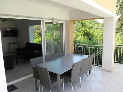 a dining room with a table and chairs on a balcony at Villa Villa Orizonte by Interhome in Favone