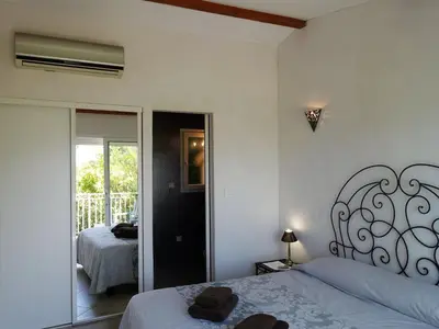 a bedroom with a bed and a mirror at Villa Villa Orizonte by Interhome in Favone