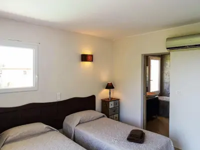 a bedroom with two beds and a window at Villa Villa Orizonte by Interhome in Favone
