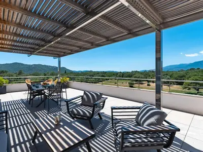 a patio with a table and chairs on a balcony at Apartment Domaine d'Arca-1 by Interhome in Porto-Vecchio