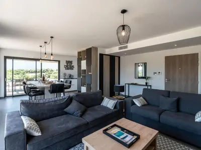 a living room with a couch and a table at Apartment Domaine d'Arca-1 by Interhome in Porto-Vecchio