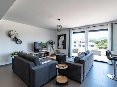 a living room with two couches and a tv at Apartment Domaine d'Arca-1 by Interhome in Porto-Vecchio