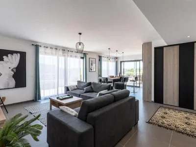 a living room with a couch and a table at Apartment Domaine d'Arca-1 by Interhome in Porto-Vecchio