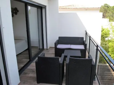 a swimming pool with chairs and a fence at Apartment Les Jardins d'Ève- F3 by Interhome in Favone