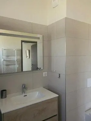 a bathroom with a toilet and a sink at Appartement spacieux 6 personnes sur le vieux port in Porto-Vecchio