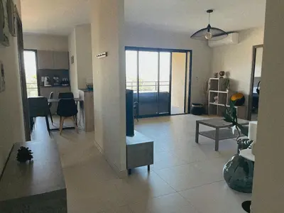 a room with a living room and a dining room at Appartement spacieux 6 personnes sur le vieux port in Porto-Vecchio