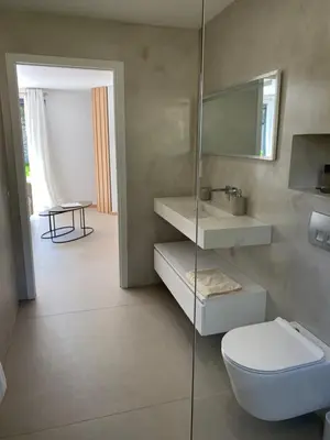 a bathroom with a toilet and a sink and a mirror at Perla Bianca in Bonifacio