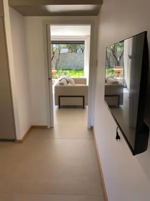 a hallway with a mirror and a cat in a room at Perla Bianca in Bonifacio