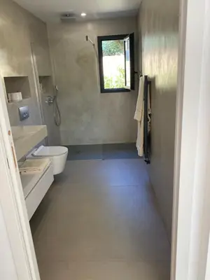 a bathroom with a toilet and a sink and a window at Perla Bianca in Bonifacio