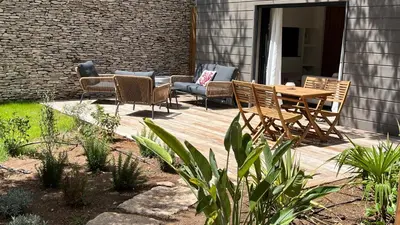 a wooden deck with chairs and a table and chairs at Perla Bianca in Bonifacio