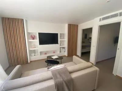 a living room with a couch and a television at Perla Bianca in Bonifacio