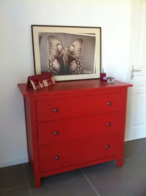 a red dresser with a picture of a butterfly on it at Rez de villa, vue panoramique mer et montagne ! in Vico