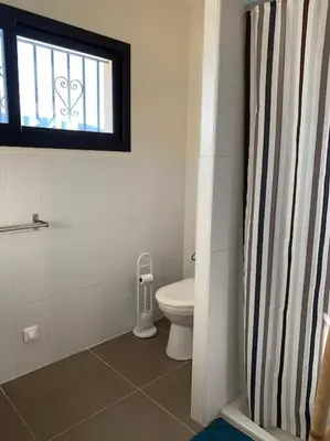 a bathroom with a toilet and a window at Rez de villa, vue panoramique mer et montagne ! in Vico