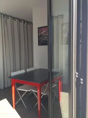 a red and black table in a room at Rez de villa, vue panoramique mer et montagne ! in Vico