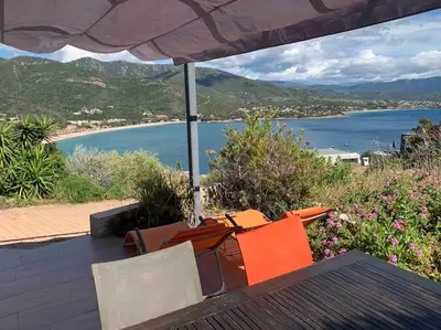 a table and chairs with a view of the ocean at Rez de villa, vue panoramique mer et montagne ! in Vico