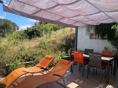 a group of chairs and a table on a deck at Rez de villa, vue panoramique mer et montagne ! in Vico