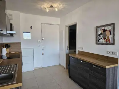 a bedroom with a bed and a balcony with a view at Studio Nautilus N7 proche centre-ville Porto-vecchio in Porto-Vecchio