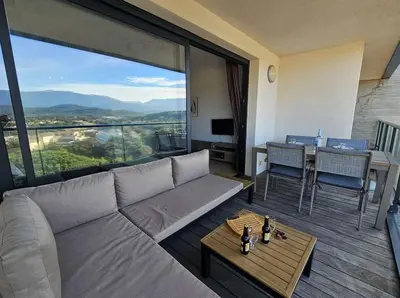a living room with a couch and a table at Studio Nautilus N7 proche centre-ville Porto-vecchio in Porto-Vecchio
