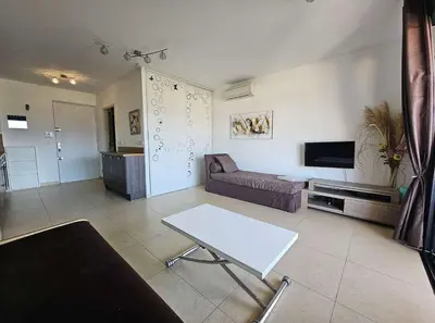 a living room with a couch and a table at Studio Nautilus N7 proche centre-ville Porto-vecchio in Porto-Vecchio