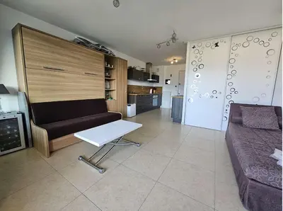 a living room with a couch and a table at Studio Nautilus N7 proche centre-ville Porto-vecchio in Porto-Vecchio
