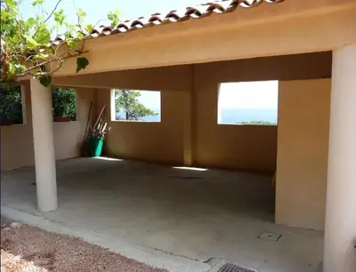a patio with two windows in a house at Villa avec vue sur la mer à Sari-Solenzara, piscine privée in Sari Solenzara