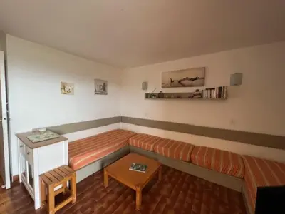 a living room with a couch and a table at Bella Vista 42, T2 vue mer piscine Porticcio in Porticcio