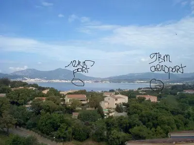 a view of a city and a body of water at Bella Vista 42, T2 vue mer piscine Porticcio in Porticcio