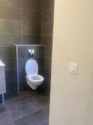 a bathroom with a toilet with the lid up at Casa Missia in Porto-Vecchio