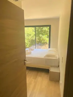 a bedroom with a bed and a window at Casa Missia in Porto-Vecchio