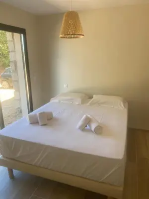 a bedroom with a bed with two towels on it at Casa Missia in Porto-Vecchio