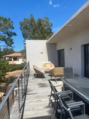 a patio with chairs and a table on a deck at Casa Missia in Porto-Vecchio