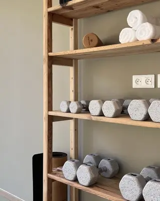 a shelf filled with stone bowls and towels at Hameau de Petripini in Sotta