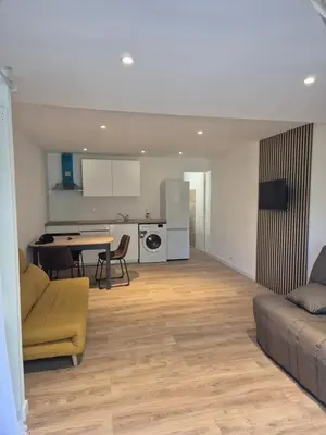 a living room with a couch and a table at Studio dans résidence calme in Porto-Vecchio