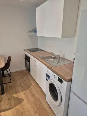 a kitchen with a washing machine and a sink at Studio dans résidence calme in Porto-Vecchio